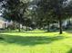 Picturesque street view of homes surrounded by lush green lawns and mature trees, offering a serene and inviting neighborhood appeal at 1197 Tallow Rd, Apopka, FL 32703