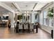 Sophisticated dining room featuring a coffered ceiling, modern lighting, and stylish decor, ideal for formal gatherings at 1491 Gateway Ln, Kissimmee, FL 34746