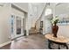 Grand foyer with hardwood floors, elegant staircase, and a decorative glass front door, offering a bright and welcoming entrance at 1491 Gateway Ln, Kissimmee, FL 34746