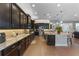 Spacious kitchen with granite countertops, dark cabinetry, and stainless steel appliances, perfect for culinary enthusiasts at 1491 Gateway Ln, Kissimmee, FL 34746