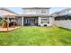 Spacious backyard with lush green grass, screened lanai, outdoor kitchen with grill and bar at 1638 Swallowtail Ln, Sanford, FL 32771
