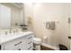 Bright powder room featuring a white vanity, neutral walls, and modern fixtures at 1638 Swallowtail Ln, Sanford, FL 32771