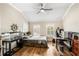 Bedroom featuring hardwood floors, a ceiling fan, shutters, and dedicated desk area at 1638 Swallowtail Ln, Sanford, FL 32771