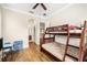 Bedroom with bunk beds, hardwood-style flooring, and neutral wall color at 1638 Swallowtail Ln, Sanford, FL 32771