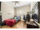 Bedroom featuring hardwood floors, a ceiling fan, shutters, and a writing desk at 1638 Swallowtail Ln, Sanford, FL 32771