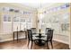 Bright dining room with hardwood floors, plantation shutters, and modern chandelier at 1638 Swallowtail Ln, Sanford, FL 32771