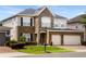 Stunning two-story home with a brick and stone facade, manicured landscaping, and a spacious two-car garage at 1638 Swallowtail Ln, Sanford, FL 32771