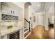 Hallway with stairs and a built-in bar area with wine storage at 1638 Swallowtail Ln, Sanford, FL 32771