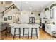 Bright, eat-in kitchen features an island with bar seating, stainless appliances, and white cabinetry at 1638 Swallowtail Ln, Sanford, FL 32771
