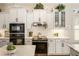 Bright kitchen featuring stainless steel appliances, white cabinets, and marble countertops at 1638 Swallowtail Ln, Sanford, FL 32771