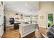 Spacious kitchen with white and dark cabinets, stainless appliances, island, and wood floors at 1638 Swallowtail Ln, Sanford, FL 32771