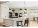 Bright, spacious kitchen with a large island, bar seating, stainless steel appliances, and hardwood floors at 1638 Swallowtail Ln, Sanford, FL 32771