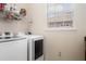 Laundry room includes modern washer and dryer, a shelf, and window to let in natural light at 1638 Swallowtail Ln, Sanford, FL 32771