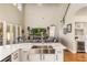 Open-concept living room with high ceilings, a large sofa, and a stylish kitchen island at 1638 Swallowtail Ln, Sanford, FL 32771