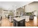 Open living space with a kitchen island, dining area, and a comfortable living room setup at 1638 Swallowtail Ln, Sanford, FL 32771