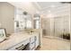 Bright bathroom featuring large vanity, glass enclosed shower, and soaking tub at 1638 Swallowtail Ln, Sanford, FL 32771