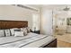 A main bedroom with wood-look floors, clerestory windows, and an en suite bathroom at 1638 Swallowtail Ln, Sanford, FL 32771