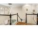 This home features a staircase with black and white railings and wood-look flooring at 1638 Swallowtail Ln, Sanford, FL 32771