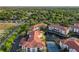 Aerial view showcasing the complex, parking, pond, tennis court and lush greenery at 2615 Maitland Crossing Way # 9 307, Orlando, FL 32810