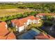 Aerial view showcasing the building's location, tennis court, nearby pond and beautiful landscaping at 2615 Maitland Crossing Way # 9 307, Orlando, FL 32810