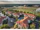 Aerial view of the property, showing the buildings, tennis court, pond, and surrounding area at 2615 Maitland Crossing Way # 9 307, Orlando, FL 32810