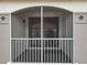 Screened balcony with white rails offering partial view of building with tile roof at 2615 Maitland Crossing Way # 9 307, Orlando, FL 32810