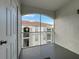 Balcony with white rails, and door to living area. Offers view of building with tile roof at 2615 Maitland Crossing Way # 9 307, Orlando, FL 32810