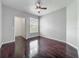 Bedroom featuring warm wood floors, closet, a large window, and a fan at 2615 Maitland Crossing Way # 9 307, Orlando, FL 32810