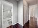 Hallway with hardwood floors, storage closets, and entrance to a full bathroom at 2615 Maitland Crossing Way # 9 307, Orlando, FL 32810