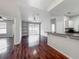 An open-plan living space boasts a kitchen counter, ceiling fan, and access to the outdoor balcony at 2615 Maitland Crossing Way # 9 307, Orlando, FL 32810