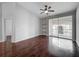 Bright living room features sliding glass doors to a balcony, ceiling fan and built-in shelving at 2615 Maitland Crossing Way # 9 307, Orlando, FL 32810