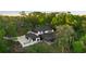 Aerial view of the property featuring a large home, swimming pool, and sprawling greenery at 305 Sweetwater Club Cir, Longwood, FL 32779
