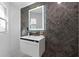 Elegant bathroom with a floating vanity, a lit mirror, and a textured accent wall at 305 Sweetwater Club Cir, Longwood, FL 32779