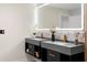 Stylish bathroom boasts dual vanities with marble countertops, gold fixtures, and backlit mirrors at 305 Sweetwater Club Cir, Longwood, FL 32779