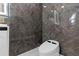 Sleek bathroom featuring a stylish toilet and modern, dark-marble-looking accent wall at 305 Sweetwater Club Cir, Longwood, FL 32779