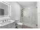 Modern bathroom featuring a glass-enclosed shower and an illuminated mirror at 305 Sweetwater Club Cir, Longwood, FL 32779