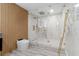 Modern bathroom features a sleek walk-in shower with marble accents, custom hardware and wood detail at 305 Sweetwater Club Cir, Longwood, FL 32779