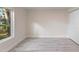 A bright bedroom features a window with tree views and updated flooring at 305 Sweetwater Club Cir, Longwood, FL 32779