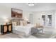 Elegant bedroom featuring light wood floors, a decorative rug and furniture, and double glass doors at 305 Sweetwater Club Cir, Longwood, FL 32779