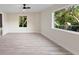 Large bedroom features multiple windows, light walls, and an updated ceiling fan at 305 Sweetwater Club Cir, Longwood, FL 32779