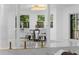 Open-concept dining area featuring modern table and chairs and bright, natural light at 305 Sweetwater Club Cir, Longwood, FL 32779