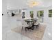 Dining room with modern lighting, a black table, white chairs, and a view into the kitchen at 305 Sweetwater Club Cir, Longwood, FL 32779