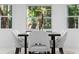 Bright dining room with nature views and modern table set with stylish chairs at 305 Sweetwater Club Cir, Longwood, FL 32779