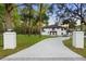 Stunning two-story home with a modern design, featuring a long driveway and lush greenery at 305 Sweetwater Club Cir, Longwood, FL 32779