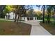 Spacious home featuring an attached garage and lengthy driveway amidst a lush, green landscape at 305 Sweetwater Club Cir, Longwood, FL 32779