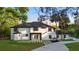 Beautiful home with modern architecture, white stucco, black trim and a well-manicured lawn at 305 Sweetwater Club Cir, Longwood, FL 32779