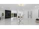Bright foyer with a glass table, marble floors, modern lighting and a view into the living room at 305 Sweetwater Club Cir, Longwood, FL 32779
