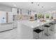 Bright kitchen featuring a large island with seating, modern appliances, and stylish pendant lighting at 305 Sweetwater Club Cir, Longwood, FL 32779