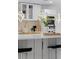 Bright kitchen island featuring bar stools, gold fixtures, and modern lighting at 305 Sweetwater Club Cir, Longwood, FL 32779