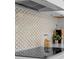 Detailed view of the kitchen's mosaic backsplash and modern appliances at 305 Sweetwater Club Cir, Longwood, FL 32779